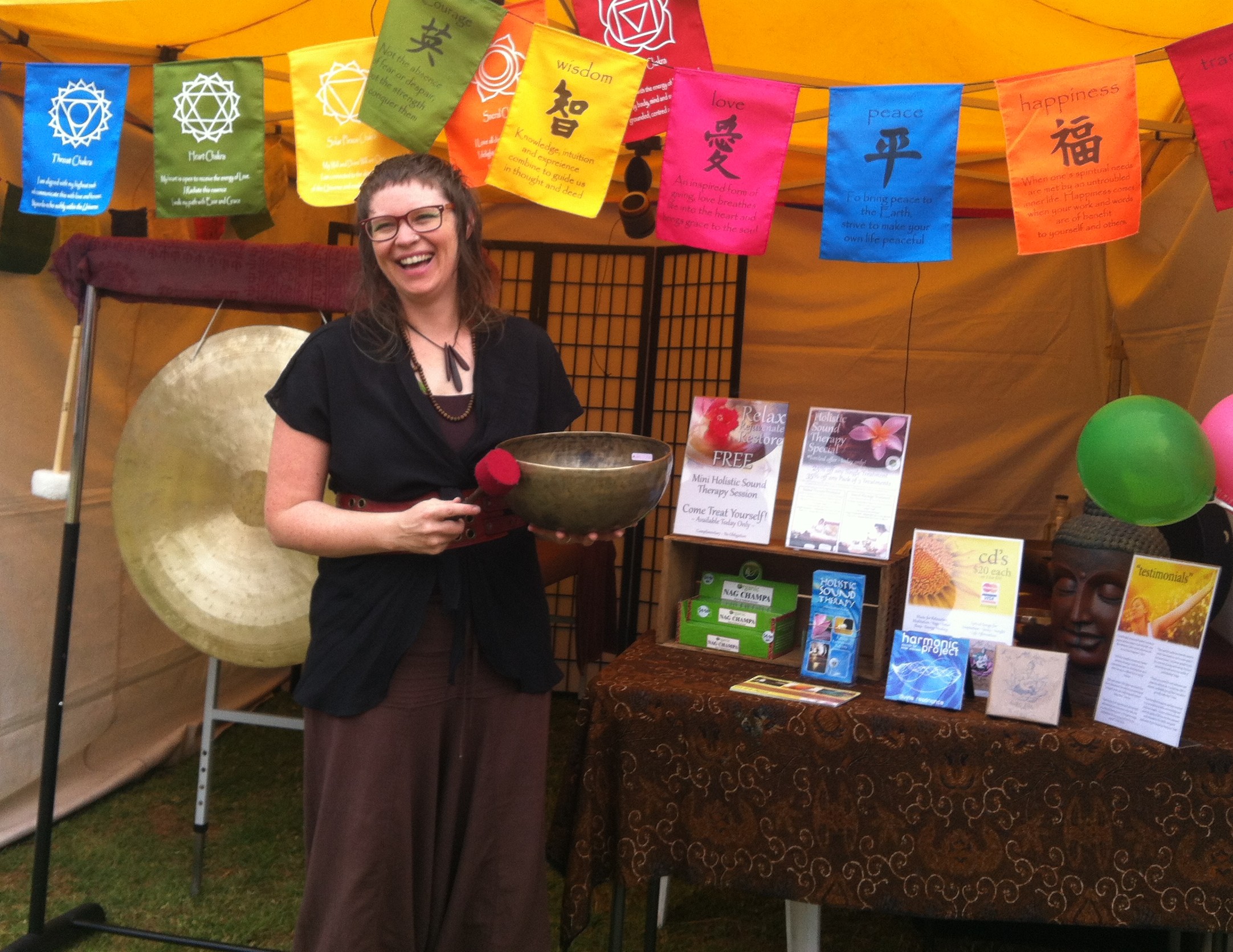 Heather Frahn Holistic Sound Therapy Stall with Himalayan Singing Bowls, Chinese Wind Gong, and Relaxation Music.